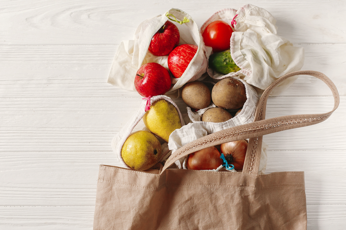 zero waste food shopping with eco natural bags with fruits and vegetables in tote