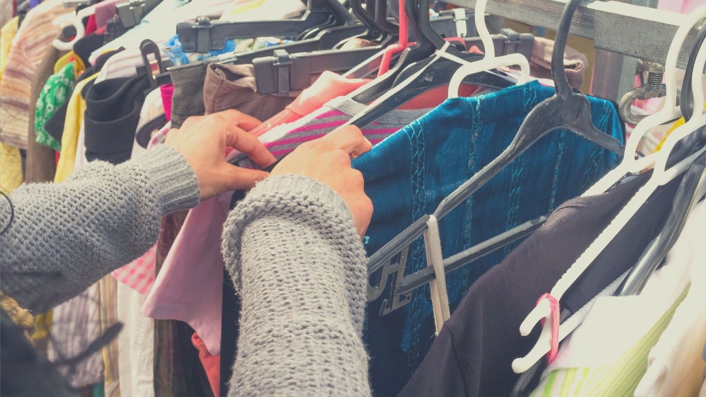 photo of person second hand shopping for ethical clothing